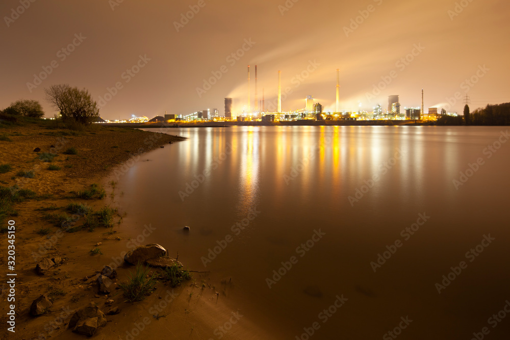 Coking Plant By River At Night