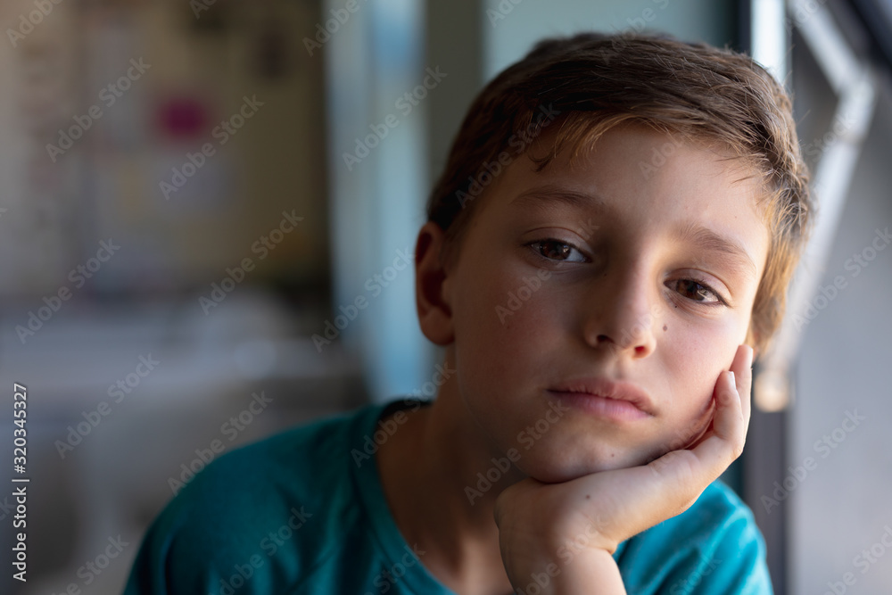 Schoolboy looking at camera in an elementary school classroom Schoolboy looking at camera in an elementary school classroom