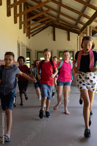 Wallpaper Mural Group of schoolchildren running in an outdoor corridor at elementary school Torontodigital.ca