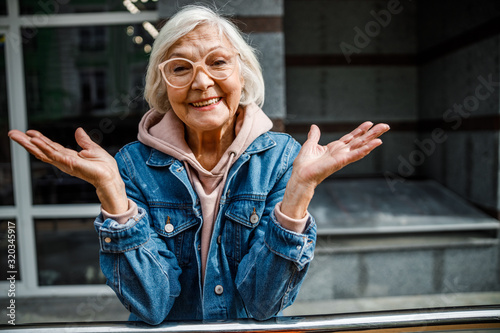 Happy mature woman standing outdoors stock photo