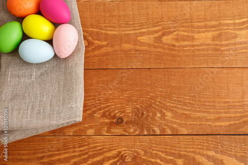 Colorful Easter Eggs On Cloth Wooden Background