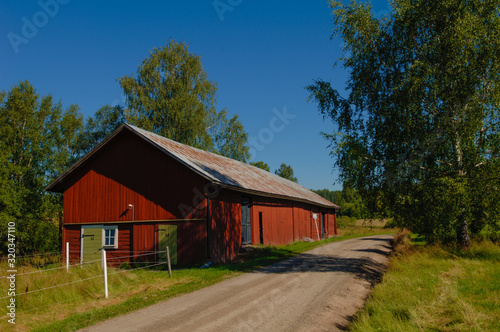 red barn by a country gravel road