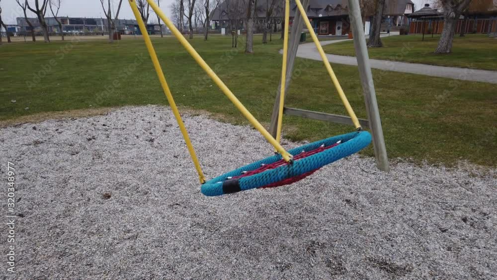 Empty childrens playground with abandoned toy on a grey winters day Empty childrens playground with abandoned toy on a grey winters day
