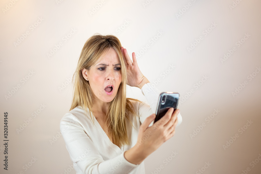 Woman in shock with her mobil Woman in shock with her mobil