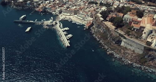 Drone zenithal aerial view of the the old town of Lipari, Aeolian islands, Sicily, Italy. Stunning panorama with Mediterranean blue sea and harbor on the background photo