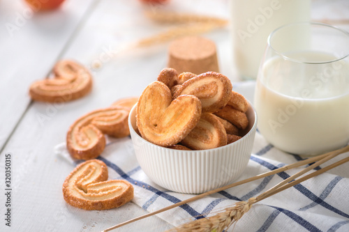Crispy cookies with milk on light background
