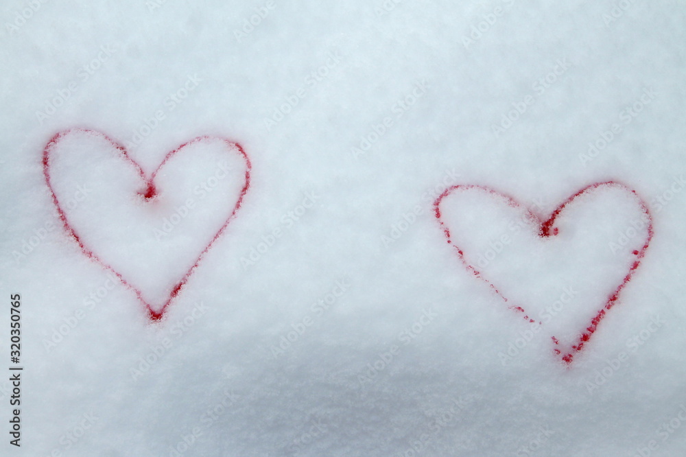 Two red hearts painted with red paint on snow symbol of love postcard for Valentines Day