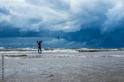 kite surfers in storm sea