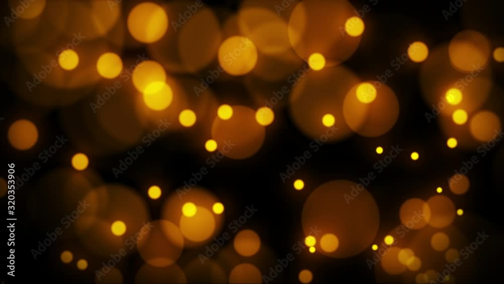 Beautiful golden bokeh blur particles abstract light on black background. 