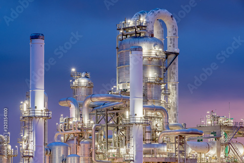 Oil refinery towers at night