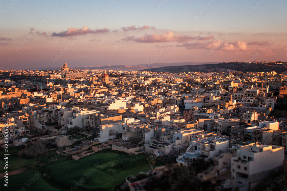 Mediterranean cityscape in sunset colors. Victoria (also known as Rabat) is the capital of Gozo Island, in Malta. It’s known for its medieval Citadel, with fortified walls. 