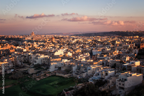 Mediterranean cityscape in sunset colors. Victoria (also known as Rabat) is the capital of Gozo Island, in Malta. It’s known for its medieval Citadel, with fortified walls. 