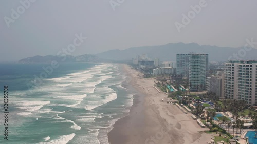 Drone Aerial View of Acapulco Riviera, Mexico, Famous Tropical Resort Under Mist photo