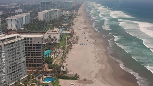 Drone Aerial View of Acapulco Waterfront Buildings, Mexico, Pacific Ocean Wavs and Sandy Beach photo