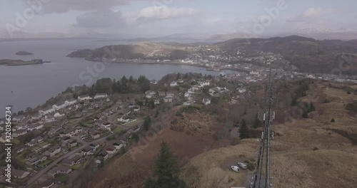 Aerial push in shot of Oban from the radio mast on a cloudy day headed north west photo