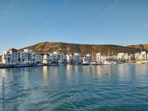 Boats at the Marina harbour in Agadir. Agadir is a major city in Morocco located on the shore of the Atlantic Ocean, near the Atlas Mountains.