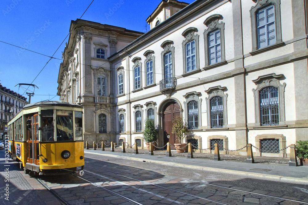 palazzo storico e tram a milano in italia, historical palace and streetcar in milan city in italy