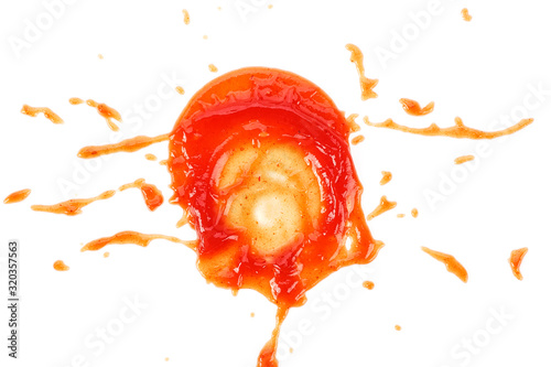 Red ketchup splashes isolated on a white background, top view.