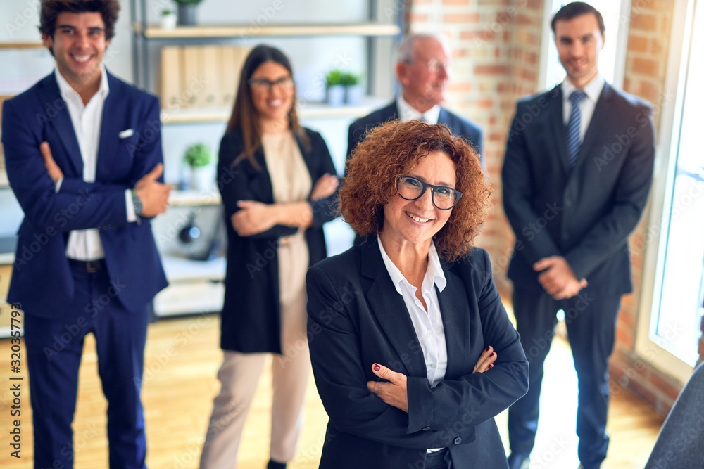 Group of business workers smiling happy and confident in a meeting. Standing with smile on face looking at camera at the office. Group of business workers smiling happy and confident in a meeting. Standing with smile on face looking at camera at the office.