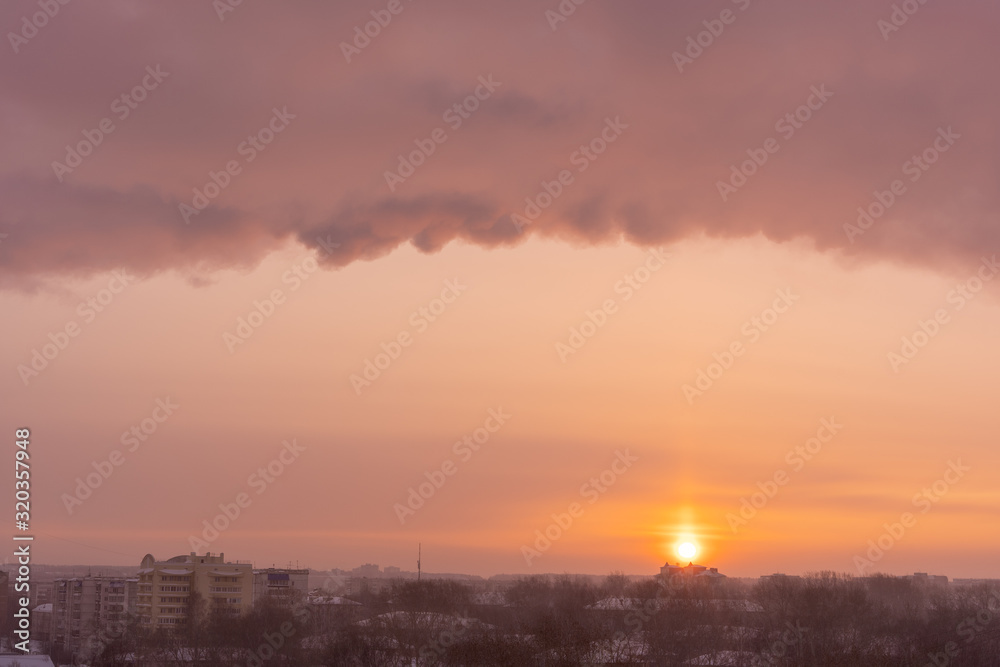 Colorful dawn over the city, sun and beautiful clouds in the sky Colorful dawn over the city, sun and beautiful clouds in the sky
