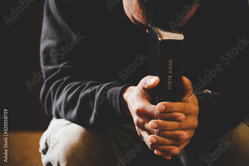 Portrait of a man praying with his eyes closed. photo