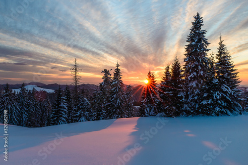 Wonderful sunset with snow and beautiful clouds photo