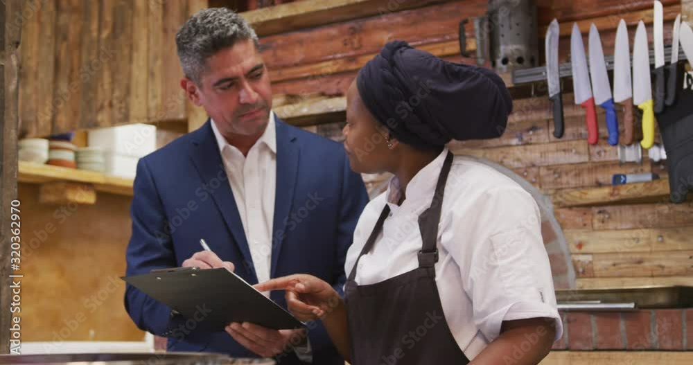 Caucasian man talking to a cook Caucasian man talking to a cook