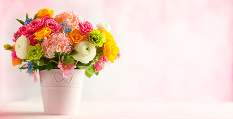 Beautiful spring flowers in vase on white wooden table. Festive concept with copy space.