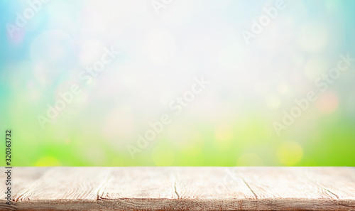Wooden table and blurred green spring or summer background. Easter concept