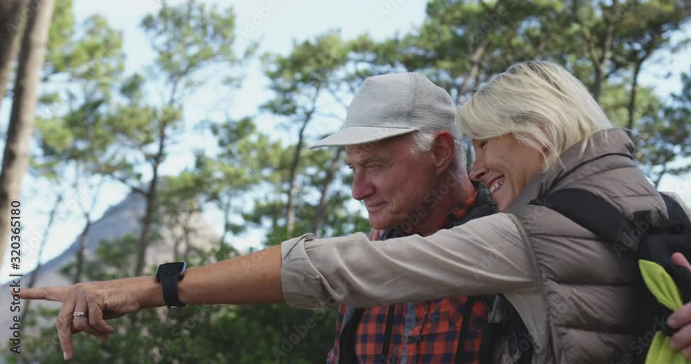 Side view of active senior couple in forest Side view of active senior couple in forest