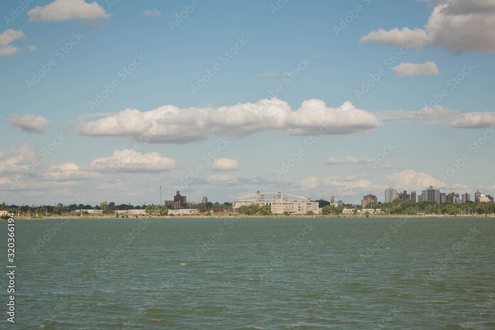 View of a lake, under the sky with clouds