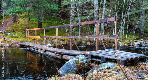 Wooden bridge over a river in a forest in Sweden