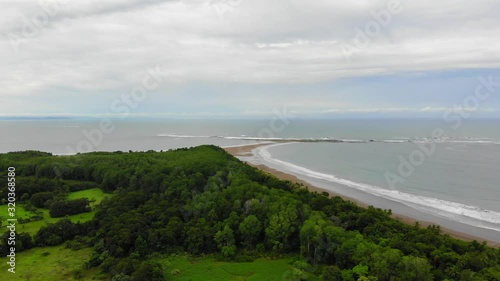 Wallpaper Mural Aerial shot of the whale tail shaped rocky point of Punta Uvita, partially cloudy weather, in south Puntarenas, Costa Rica. Torontodigital.ca