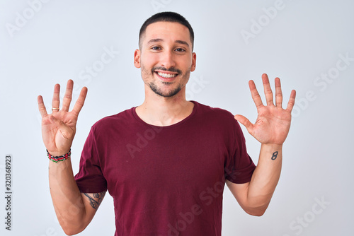 Young handsome man standing over isolated background showing and pointing up with fingers number nine while smiling confident and happy.