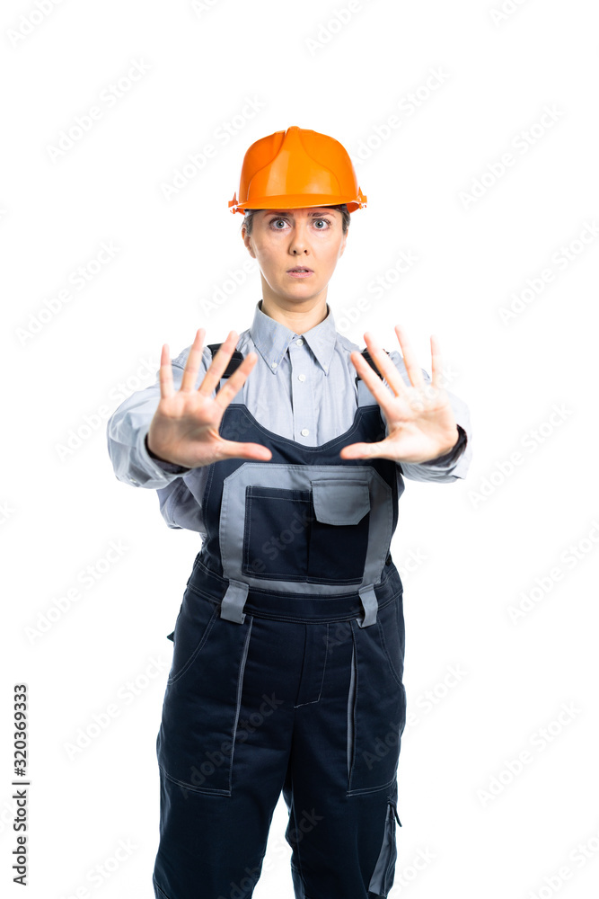 Female engineer builder shows hand gestures STOP. Isolated Female engineer builder shows hand gestures STOP. Isolated