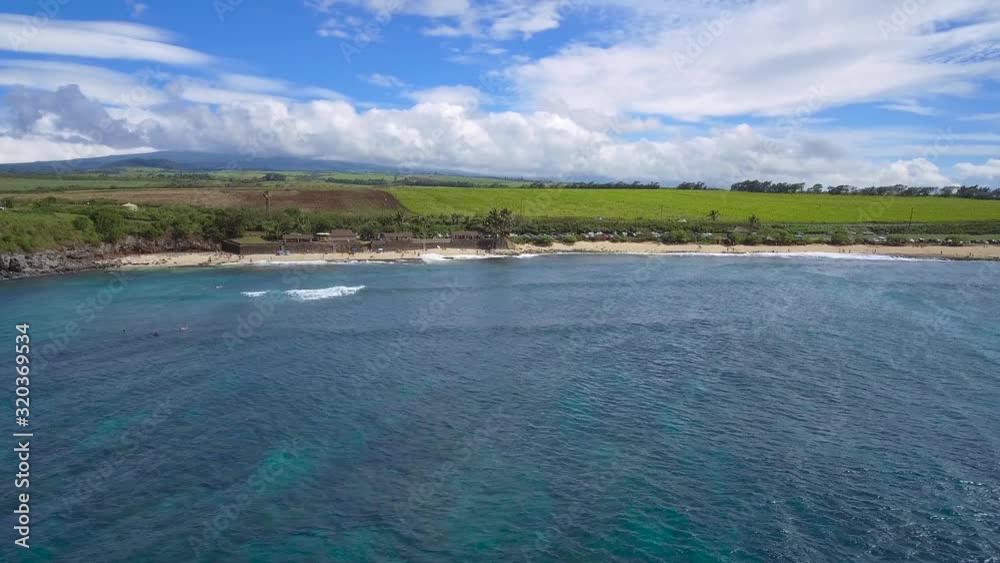 Colorful sea surface vibrating by wind on calm bay shining under bright sky with frozen white clouds in Hawaii Colorful sea surface vibrating by wind on calm bay shining under bright sky with frozen white clouds in Hawaii