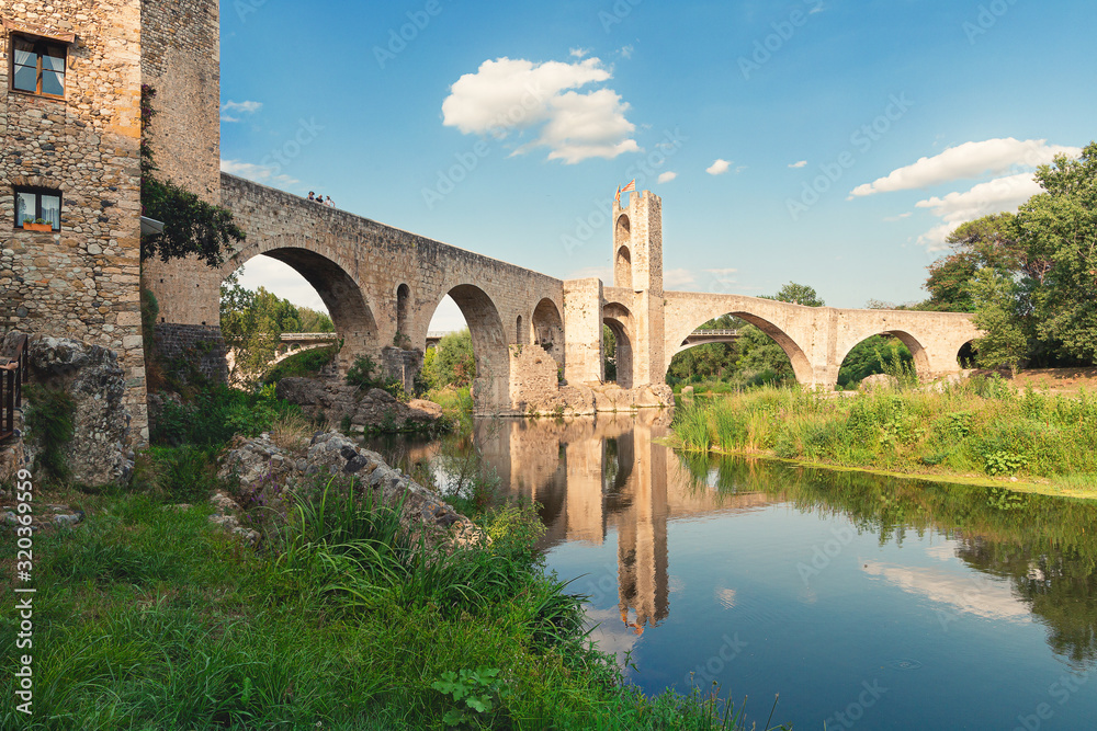 View of the stone bridge over the Fluvia River in Besalu, Catalonia.