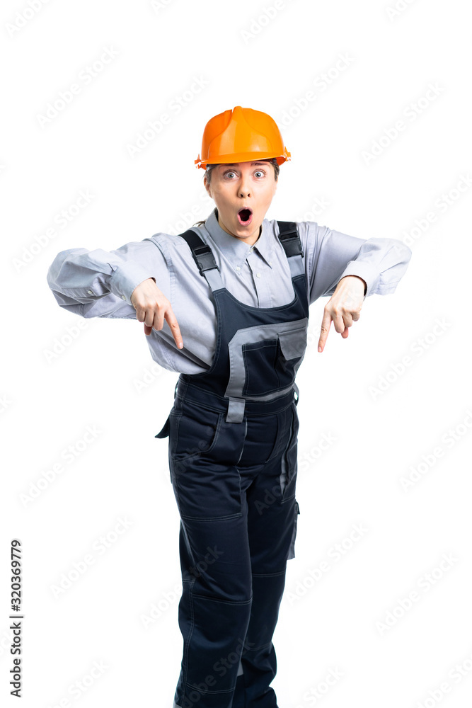Female construction engineer points fingers to the side from a blank of text. Isolated Female construction engineer points fingers to the side from a blank of text. Isolated