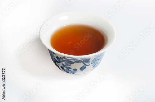 Dry Chinese oolong tea leaf and oolong tea in traditional cup on white, gaiwan tea