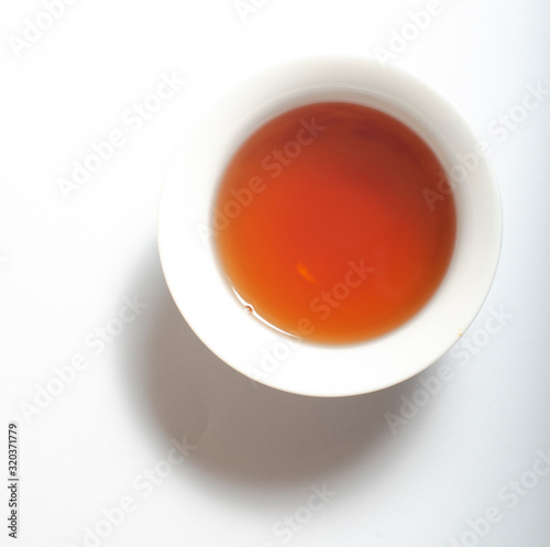 Dry Chinese oolong tea leaf and oolong tea in traditional cup on white, gaiwan tea