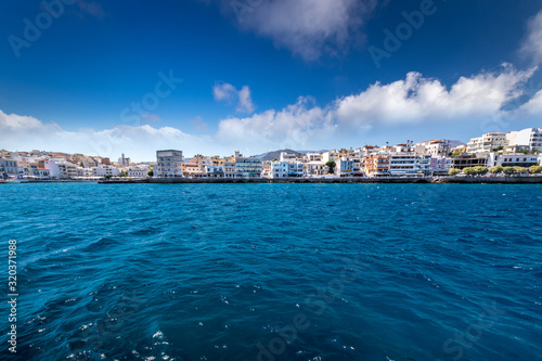 Agios Nikolaus coastline on a sunny day with clear turquoise sea and cliffs. Crete, Greece, Aegean Sea. Elunda. photo