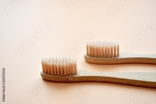 Eco-friendly bamboo tooth brush. Zero waste set on light beige natural background. Flat lay. Top view. Copy space. 