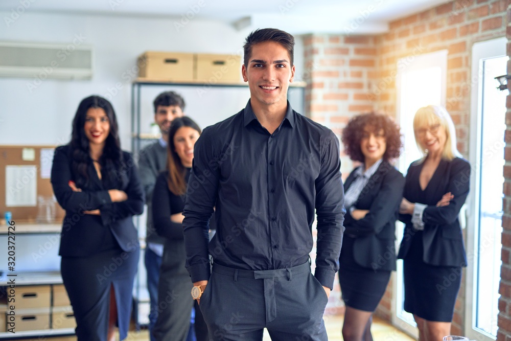 Group of business workers smiling happy and confident. Posing together looking at the camera, young handsome man with smile on face at the office Group of business workers smiling happy and confident. Posing together looking at the camera, young handsome man with smile on face at the office