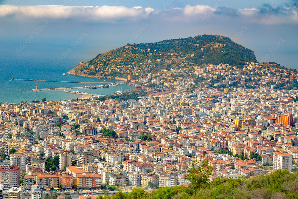 Alanya skyline with a view ath the harbour and a mountain with a fort. Main city attractions at the Midterranian region.