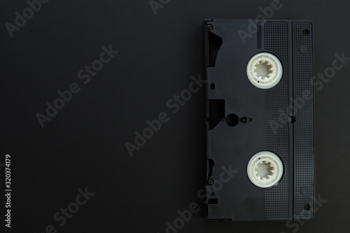Old video cassette isolated on black background.
