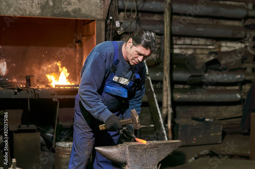 mature male blacksmith at work