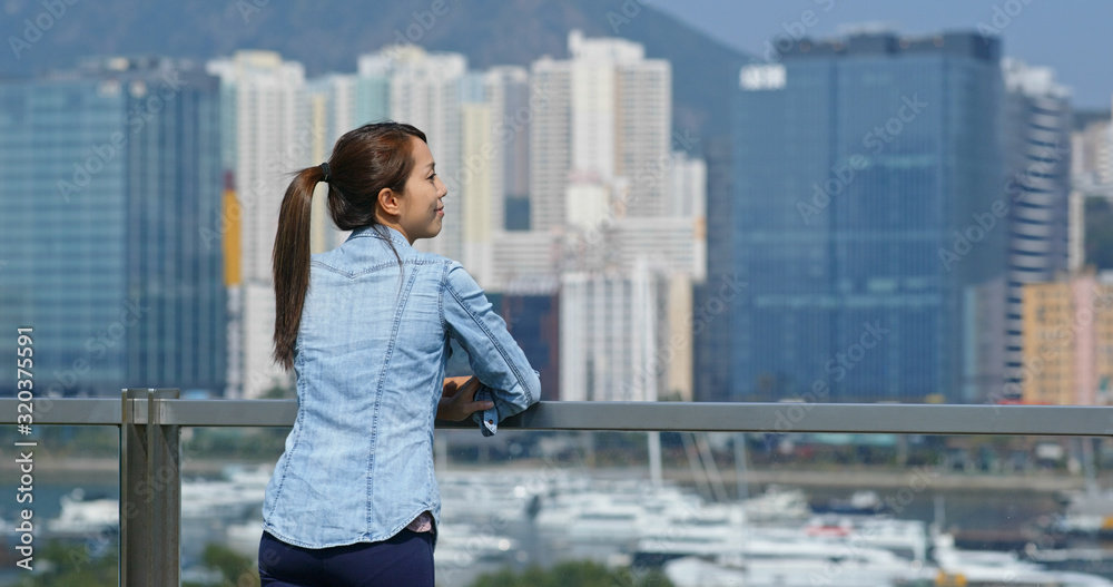 Woman look at the city view in Hong Kong