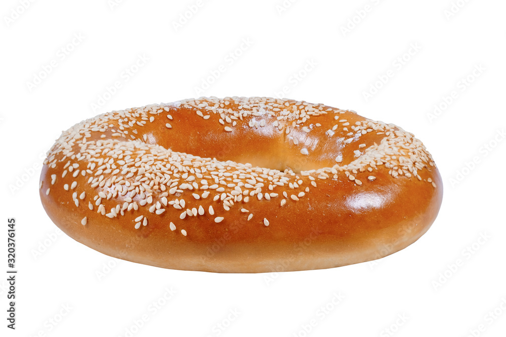 Fresh bagel with sesame seeds isolated on white. Homemade baking.