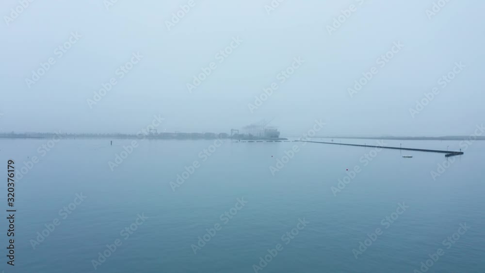 Blue breakers in the water under foggy skies and humidity during the day. Blue breakers in the water under foggy skies and humidity during the day.