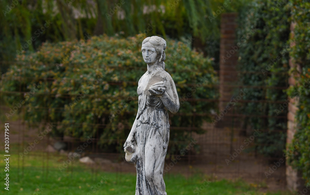 Statue of woman in a garden